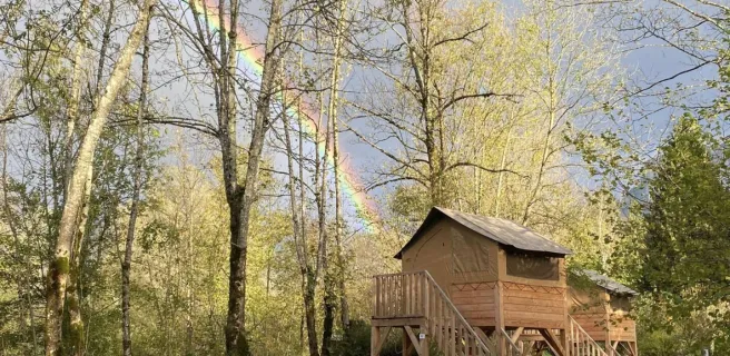Cabins on stilts at the camping l'Arc en Ciel